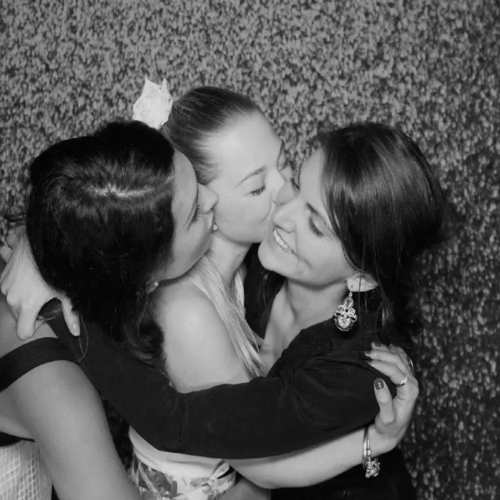 Friends embracing in the photobooth